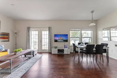 a living room with a table and a dining room at New 4BDR House near Disney 8979 in Kissimmee