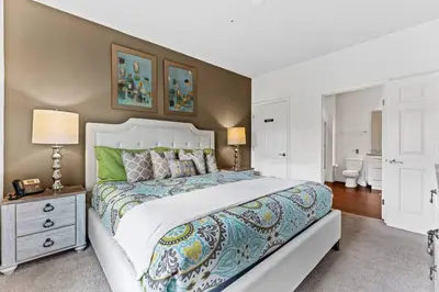 a bedroom with a large bed and a bathroom at New 4BDR House near Disney 8979 in Kissimmee