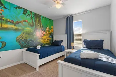 a bedroom with two beds and a painting on the wall at Family House near Disney - 5109 in Kissimmee