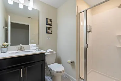 a bathroom with a toilet and a sink and a shower at Amazing 5Bdr House with pool 4857 in Kissimmee