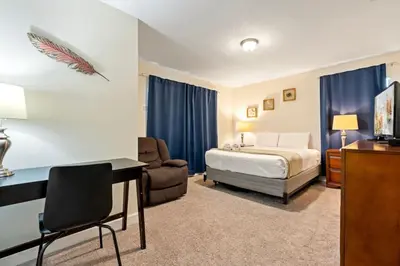 a hotel room with a bed and a desk and a bedroom at Amazing 5Bdr House with pool 4857 in Kissimmee
