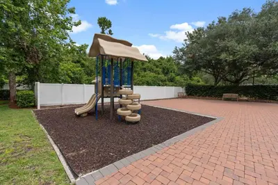 a playground with a slide and an umbrella at Luxury 4BDR House close to Parks in Kissimmee