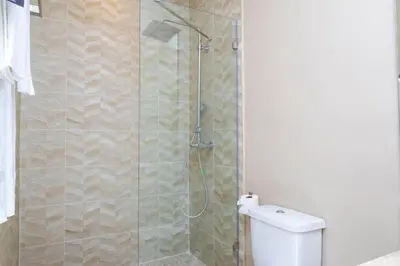 a bathroom with a shower with a toilet at Luxury 3BDR House near Disney 7527 in Orlando