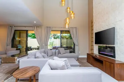 a living room with a white couch and a tv at Luxury 3BDR House near Disney 7527 in Orlando