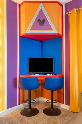 a colorful room with two chairs and a computer monitor at Family 5BR Retreat w Pool Near Disney in Kissimmee