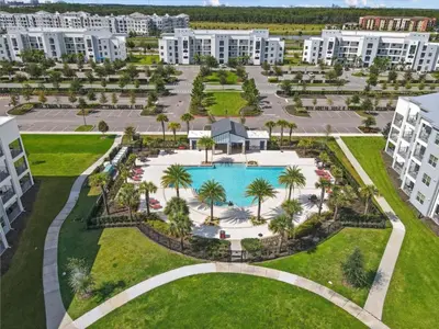 an aerial view of a resort with a pool and palm trees at 3 Bedrooms 2 Bathrooms Storey Lake 3180-308 in Kissimmee