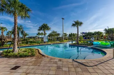 a swimming pool with palm trees in a park at 3 Bedrooms 2 Bathrooms Storey Lake 3180-308 in Kissimmee