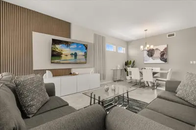 a living room with a couch and a dining room at 3 Bedrooms 2 Bathrooms Storey Lake 3180-308 in Kissimmee