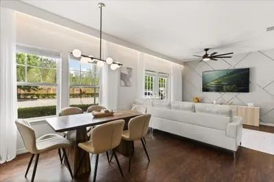 a living room with a white couch and a table at 4 Bedrooms 3 Bathrooms Lucaya Village 19-104 in Kissimmee