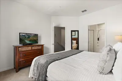 a bedroom with a bed and a television on a dresser at 4 Bedrooms 3 Bathrooms Lucaya Village 19-104 in Kissimmee