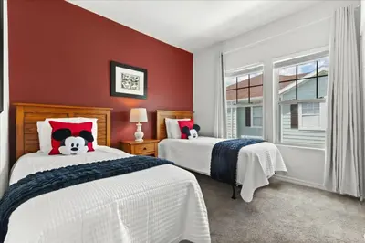 two beds in a bedroom with red walls at 4 Bedrooms 3 Bathrooms Lucaya Village 19-104 in Kissimmee