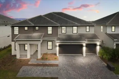 a large house with a garage in front of it at 15 Bedrooms155 Bathroomsveranda Palms 2477Rd in Kissimmee