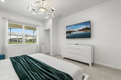 a white bedroom with a bed and a dresser at 15 Bedrooms155 Bathroomsveranda Palms 2477Rd in Kissimmee