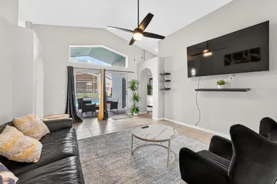 a living room with a couch and a table at Entire Disney Retreat Home minutes from Disney, Shopping, and Restaurants 4br,2ba,7beds sleeps 10 in Orlando