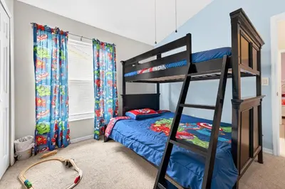 a bedroom with a bunk bed and a bed at Entire Disney Retreat Home minutes from Disney, Shopping, and Restaurants 4br,2ba,7beds sleeps 10 in Orlando