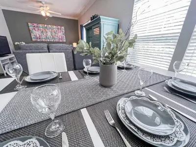a dining room table with plates and wine glasses at Perfect vacation spot near Disney 7105 in Kissimmee