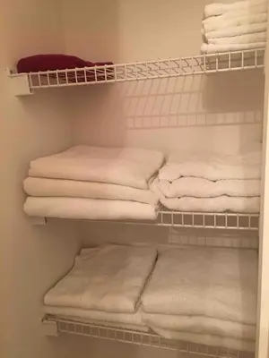 a closet filled with lots of white towels on shelves at Home Away From Home in Kissimmee