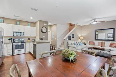 a kitchen and living room with a wooden table in a room at amazing 4bdr house near Disney in Kissimmee