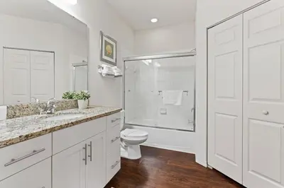 a white bathroom with a toilet and a sink at amazing 4bdr house near Disney in Kissimmee