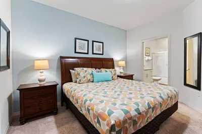 a bedroom with a bed with two night stands and two lamps at amazing 4bdr house near Disney in Kissimmee