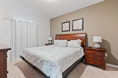 a bedroom with a bed and a dresser and a window at amazing 4bdr house near Disney in Kissimmee