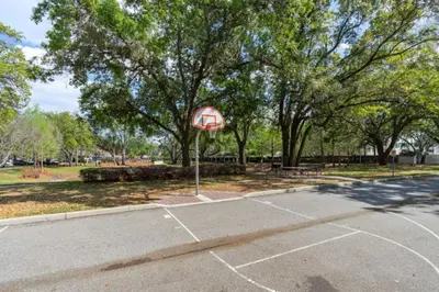 a basketball court with a stop sign in a park at Luxury 4 BDR House near Disney 11105 in Kissimmee