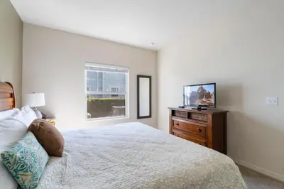 a bedroom with a bed and a flat screen tv at Amazing 4bdr house in Disney 20104 in Kissimmee
