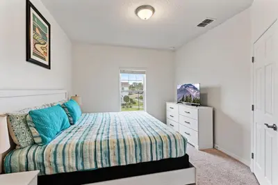 a bedroom with a bed and a window at Amazing 4BDR few miles from Disney in Kissimmee