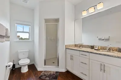 a white bathroom with a toilet and a shower at Amazing 4BDR few miles from Disney in Kissimmee