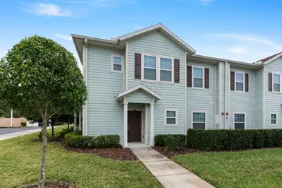 a house with blue siding and a tree at Amazing 4BDR few miles from Disney in Kissimmee