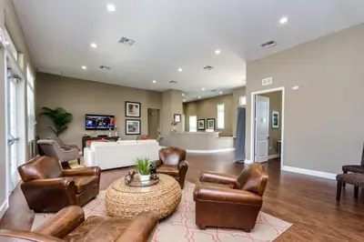 a living room with leather chairs and a table at Amazing 4BDR few miles from Disney in Kissimmee