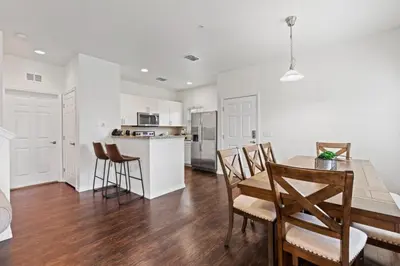a kitchen and dining room with a table and chairs at Amazing 4BDR few miles from Disney in Kissimmee