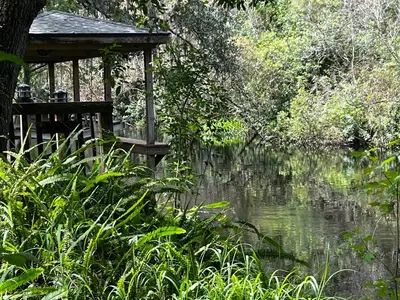 a gazebo sitting next to a body of water at Amazing Waterfront Apt near Disney and Lake Tohoa in Kissimmee
