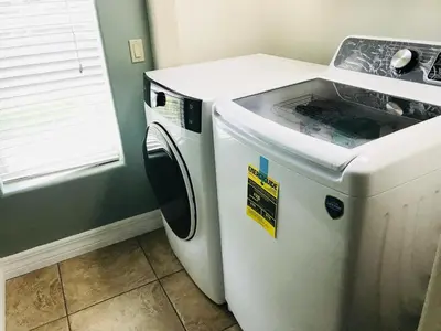a washer and dryer in a room with a window at Amazing Waterfront Apt near Disney and Lake Tohoa in Kissimmee