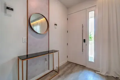 a mirror on a wall in a room with a dresser at 3417 Brand New 3BD Family Home Near Disney in Kissimmee