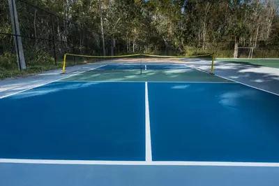 a tennis court with a net on top of it at Luxury Studio Gem 10min to Disney Pool and Amenities in Kissimmee