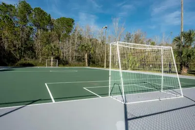a tennis court with a net on top of it at Luxury Studio Gem 10min to Disney Pool and Amenities in Kissimmee