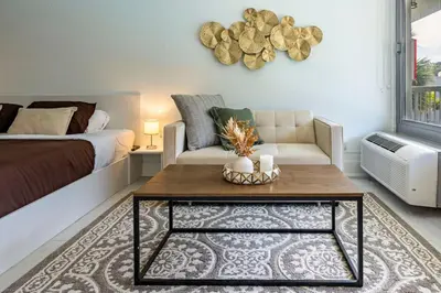 a living room with a couch and a coffee table at Luxury Studio Gem 10min to Disney Pool and Amenities in Kissimmee