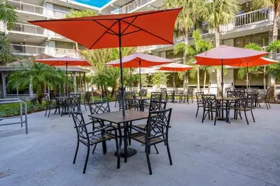 a group of tables and chairs with umbrellas at Luxury and Cozy Gem 15min to Disney Free Parking in Kissimmee