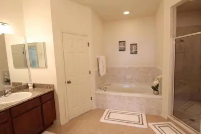 a bathroom with a tub and a sink at 4BDR with pool near Disney 1014 in Kissimmee