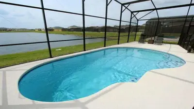 a large swimming pool with a view of the water at 4BDR with pool near Disney 1014 in Kissimmee