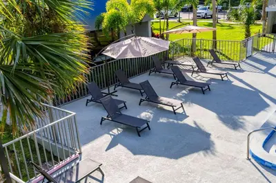 a group of chairs and umbrellas on a patio at Modern New APT in perfect Location only 10min to Disney in Kissimmee