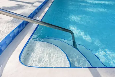 a swimming pool with a ramp in the water at Modern New APT in perfect Location only 10min to Disney in Kissimmee