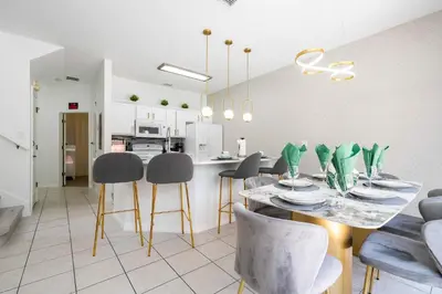 a kitchen and dining room with a table and chairs at Gorgeous 4Bd w Pool at Encantada Resort 8523 in Kissimmee
