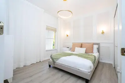 a white bedroom with a bed and a window at Gorgeous 4Bd w Pool at Encantada Resort 8523 in Kissimmee