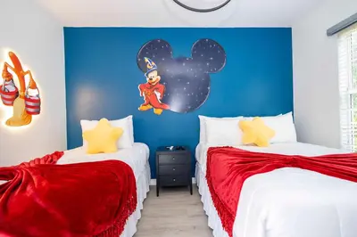 a bedroom with two beds and a blue wall at Gorgeous 4Bd w Pool at Encantada Resort 8523 in Kissimmee