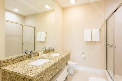 a bathroom with two sinks and a toilet and a shower at Super Close to Disney Magic Stays in Orlando