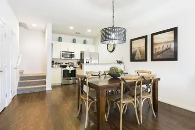 a kitchen and dining room with a wooden table and chairs at Amazing 3Bdr House near Disney 16106 in Kissimmee