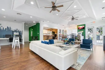 a living room with a white couch and blue chairs at Amazing 3Bdr House near Disney 16106 in Kissimmee