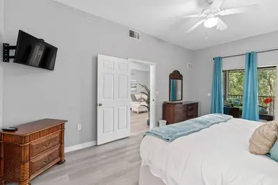 a bedroom with a bed and a dresser and a television at Finding Nemo House at Caribe Cove Resort - Sage Vacations in Kissimmee
